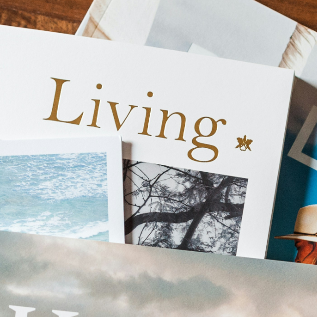 Close up of books stacked ontop each other with one book that says "Living" in foil stamping.
